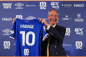 Nigel Farage posing with an Ipswich Town shirt