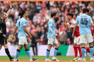Referee Peter Bankes shows a yellow card to Piero Hincapie of Arsenal during the Carabao Cup Final match Arsenal and between Manchester City at Wembley Stadium