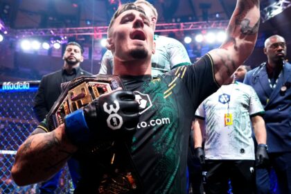 Tom Aspinall celebrates after winning the UFC interim heavyweight title at UFC 295