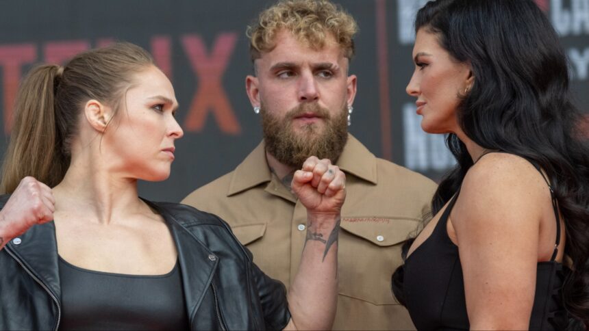 Ronda Rousey and Gina Carano facing off in front of Jake Paul