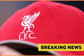 Liverpool logo on hat, and breaking news banner
