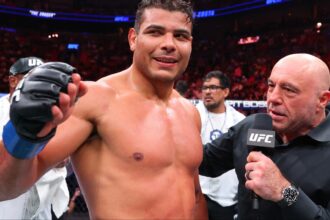 Paulo Costa is interviewed by Joe Rogan in the cage at UFC 327