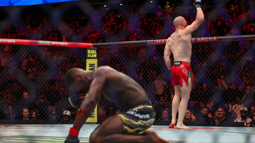 Israel Adesanya reacts as Joe Pyfer celebrates at UFC Seattle