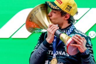 Antonelli kisses the winners' trophy on the Shanghai podium