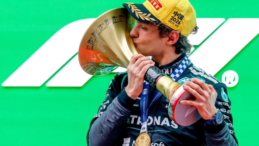 Antonelli kisses the winners' trophy on the Shanghai podium